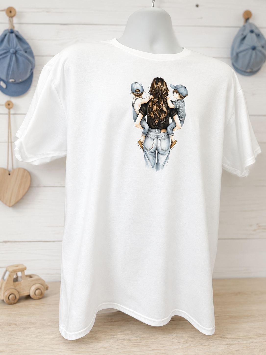 Short-sleeved T-shirt featuring a design of a mother carrying two children wearing denim caps.