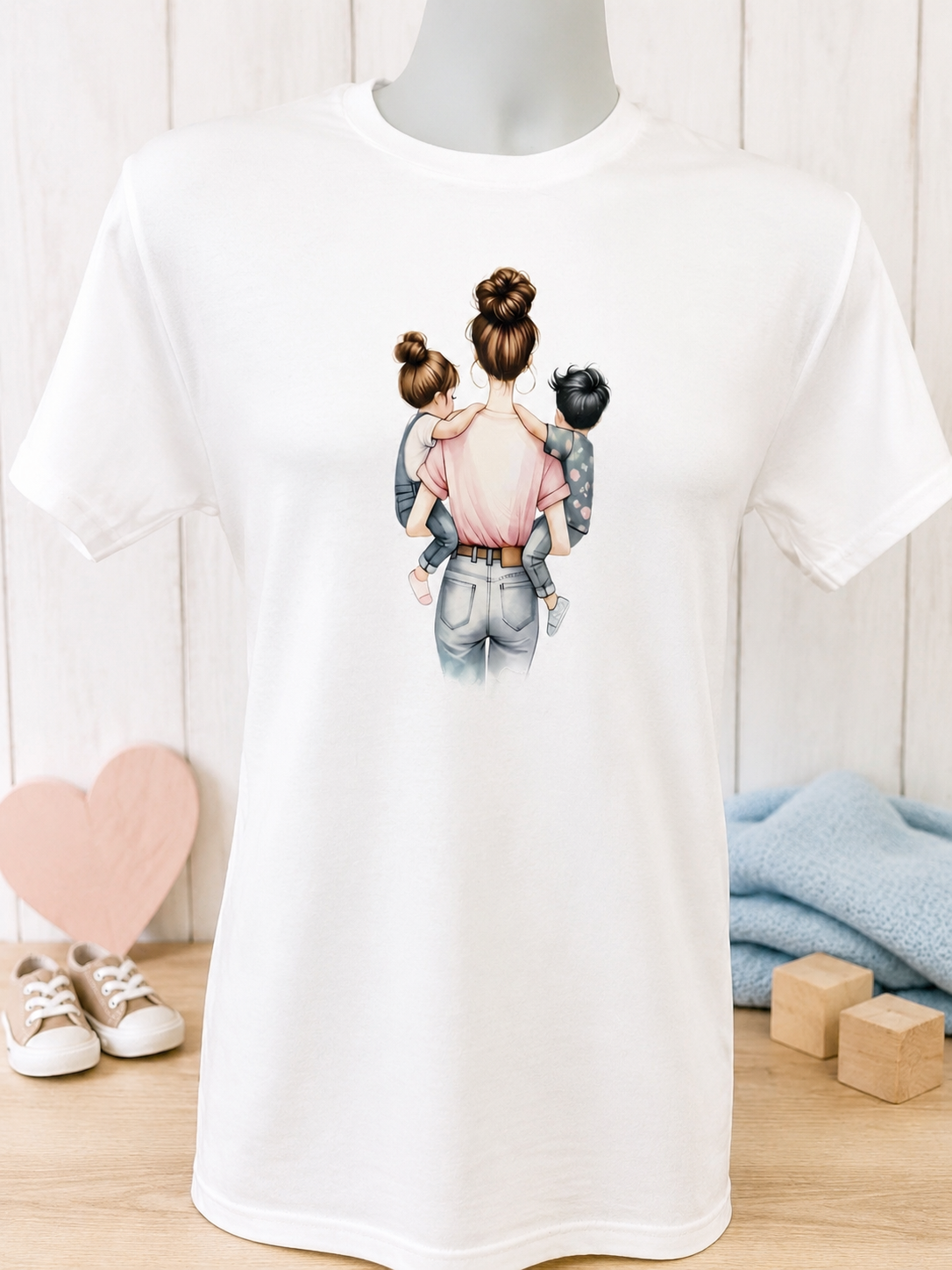 Short-sleeve T-shirt featuring a design of a mother carrying a girl and a boy in her arms.