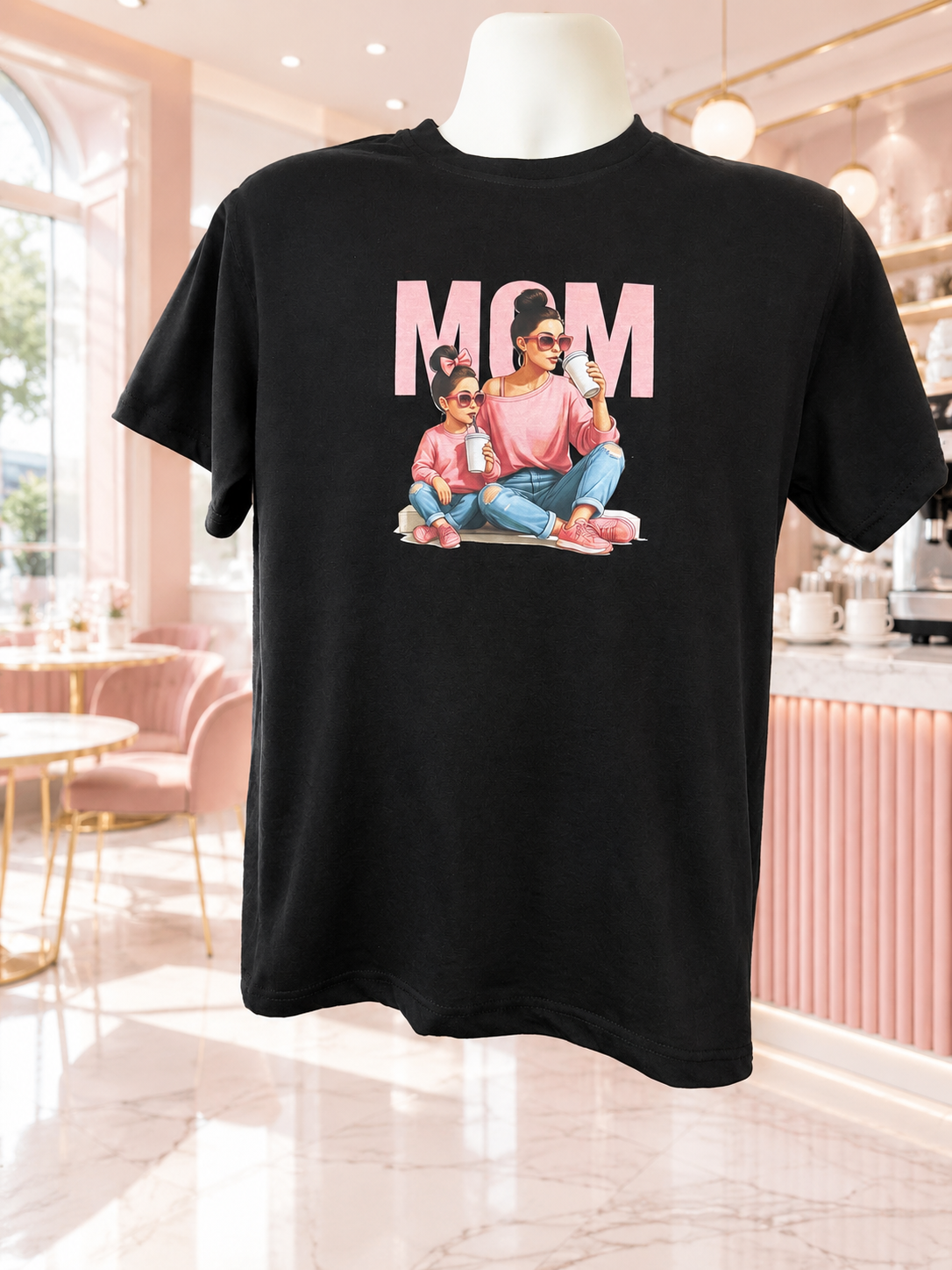 Beautiful short-sleeved shirt featuring a mother-and-daughter design; both are wearing sweaters and pink shoes, with the word "MOM" in pink.