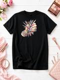 Short-sleeved T-shirt featuring a design of hands wearing bracelets and holding manicure supplies.