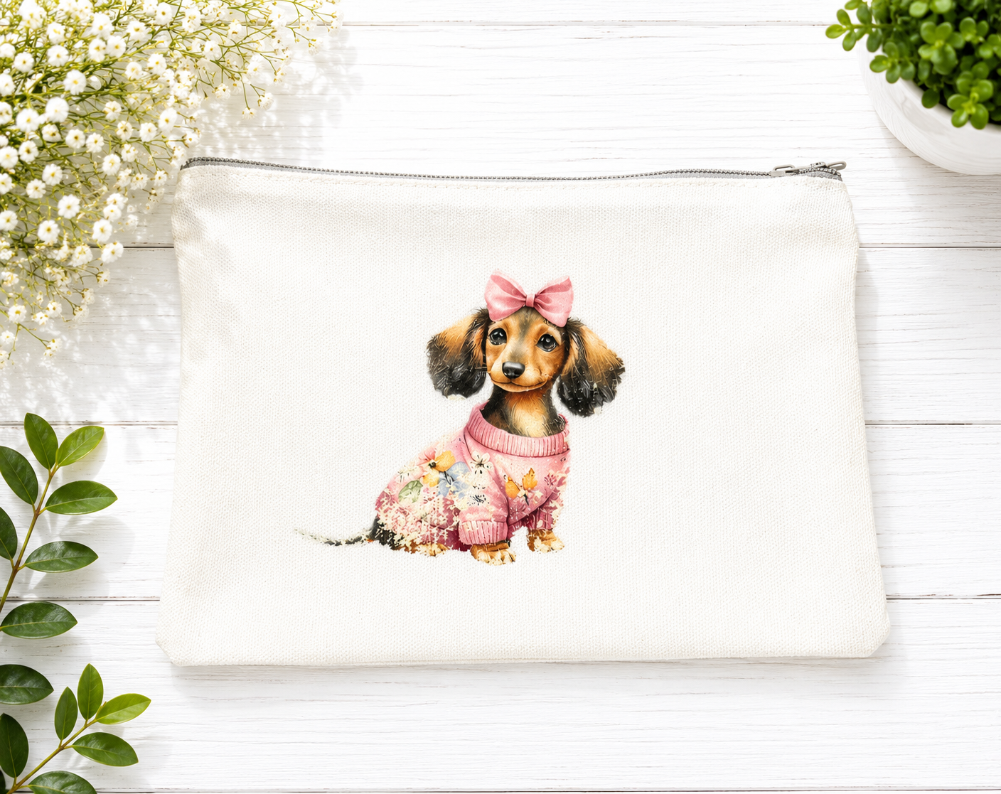 Beautiful zippered canvas case or pencil case featuring a design of a little dog with a bow on its head and a pink sweater